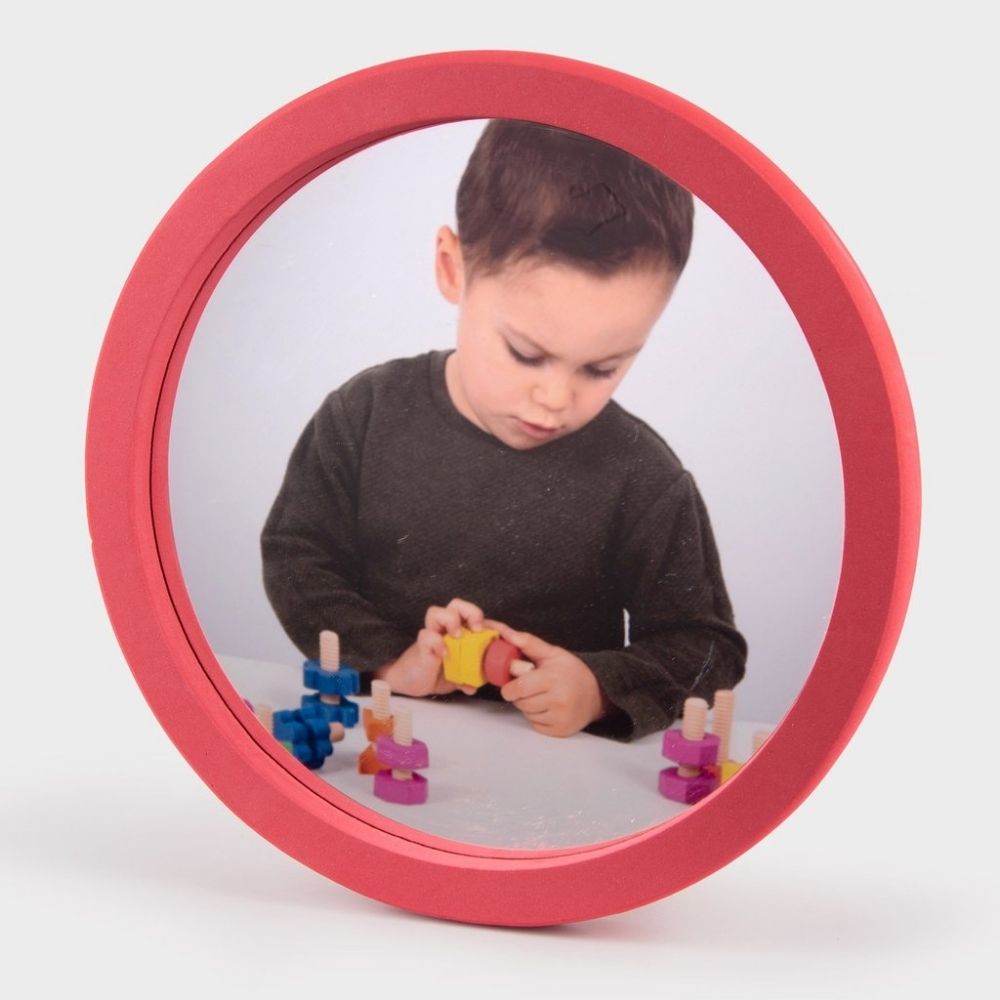 Softie Round Wall Mirror, The Softie Round Wall Mirror is made using safety acrylic mirrors surrounded by tough EVA foam frames. The Round softie mirror is a perfect sensory addition which will encourage children to explore there own features and surroundings and do so whilst enjoying the benefit of safe sensory play. The large acrylic mirrored surface is a great way for children of all ages to learn about reflection, self observation and awareness, the reflection of light and colour and symmetry. Supplied 
