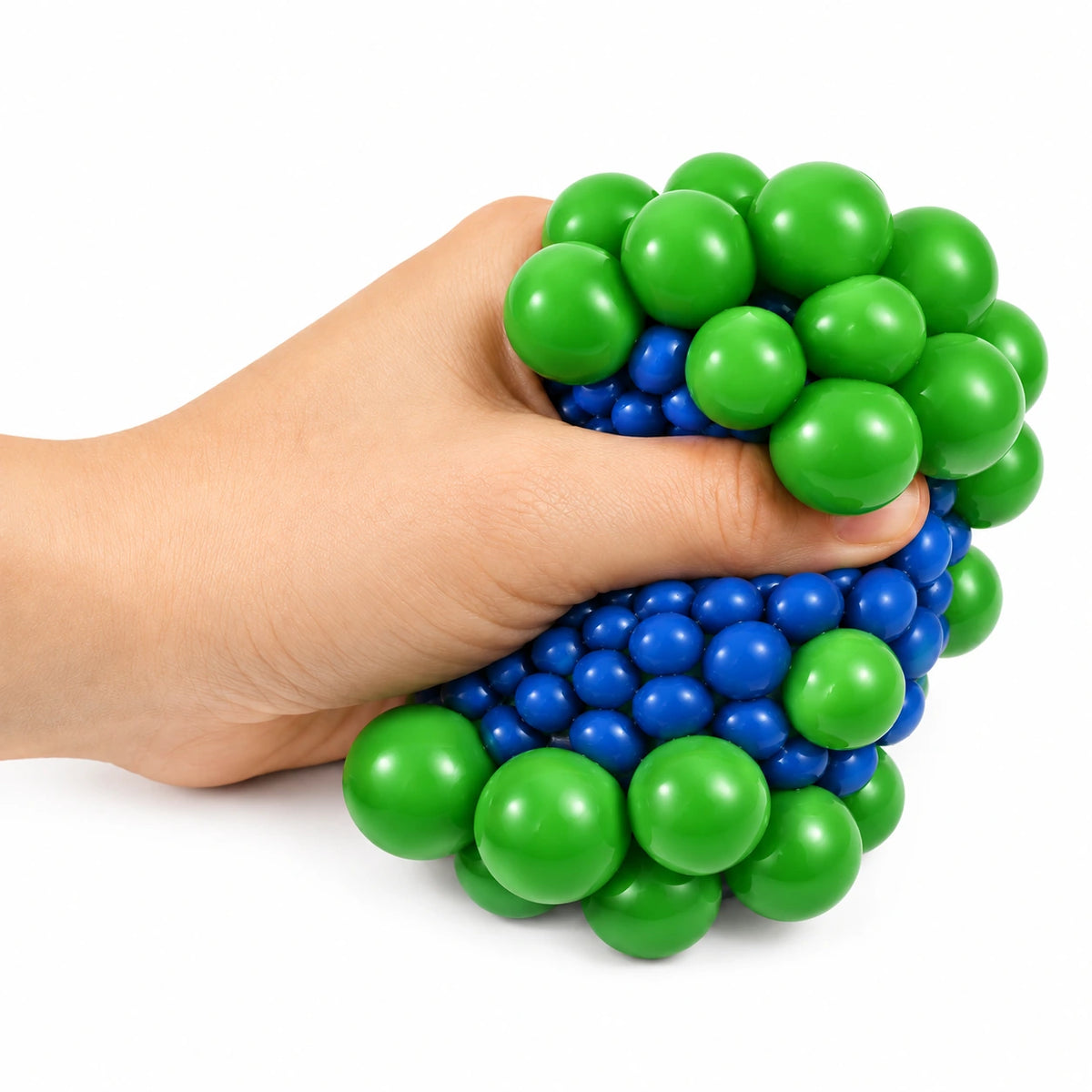Hand squeezing a stress ball to form green and blue bubbles
