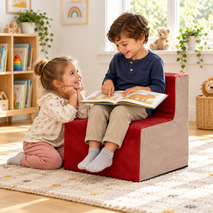 Two children sharing book beside Wine suede chair