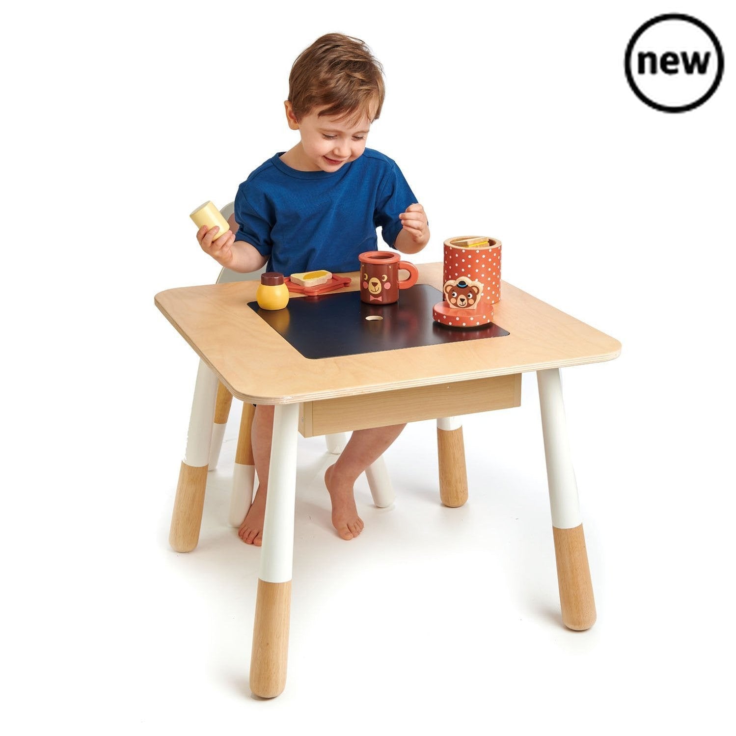 Tenderleaf Toys Wooden Forest Table, This beautiful and fun forest table by Tender Leaf Toys will brighten up any room. Perfectly sized for little ones using quality plywood and a fun design this table is great for table based play, learning, snack time, arts and crafts or even to sit and read a book to their favorite teddy. Comes with a clever chalkboard central panel and a hidden compartment underneath to store the crayons and chalks. NOTE: The removable centre piece has been upgraded to plywood rather th