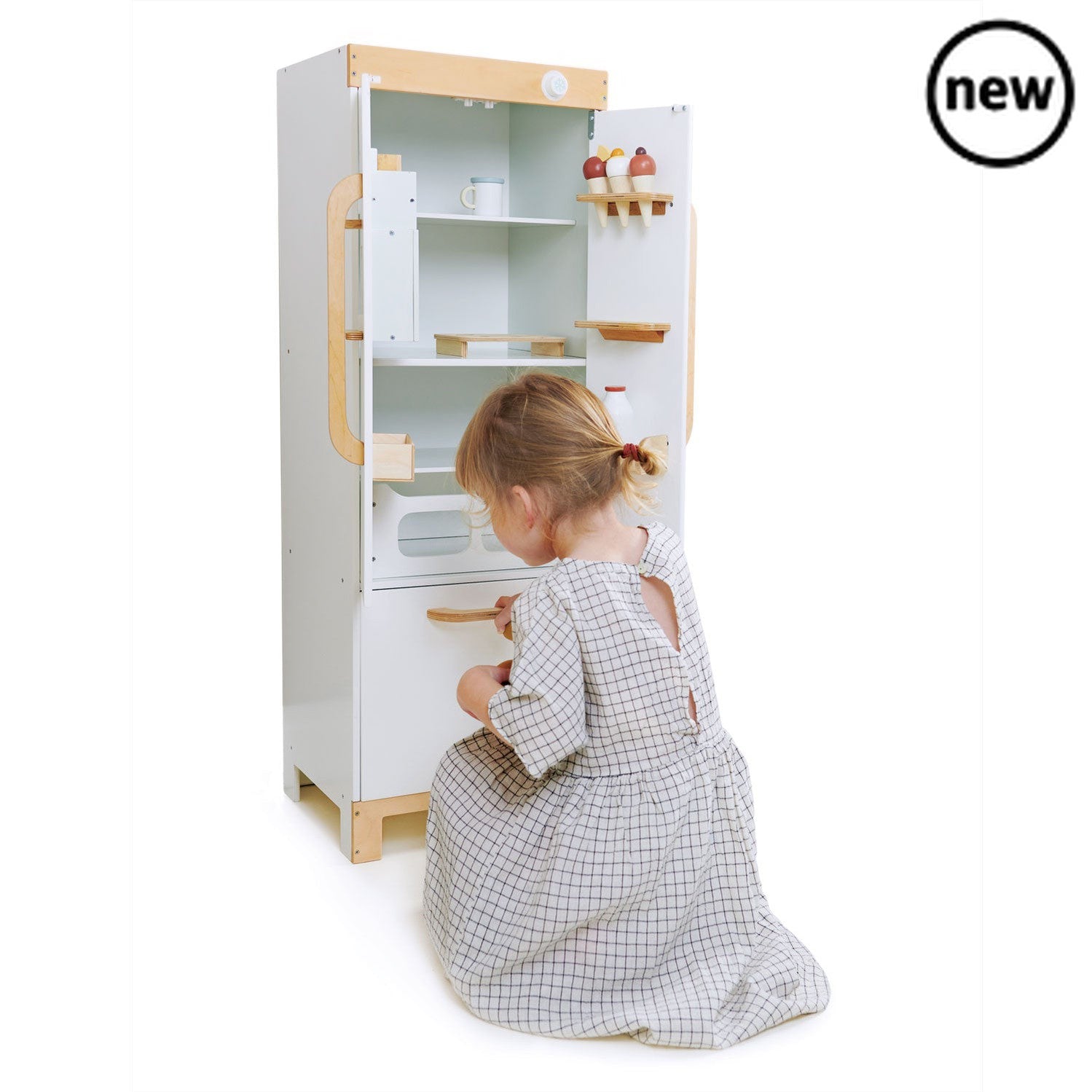 Tenderleaf Toys Wooden Refrigerator, Need somewhere to chill your ice-creams? A stand-alone white fridge-freezer makes a great addition to our La Fiamma Grand Kitchen. This stylish fridge has a real wow factor with a unique functioning ice cube dispenser which drops ice cubes with the press of a button. Comes with: 3 ice cream cornets 3 brown eggs on an egg stand a bottle of milk and two magnets! Great for role play and creative play! Product size: 1.081x0.386x0.09meters (HxWxD) Suitable for ages 3+, Tender