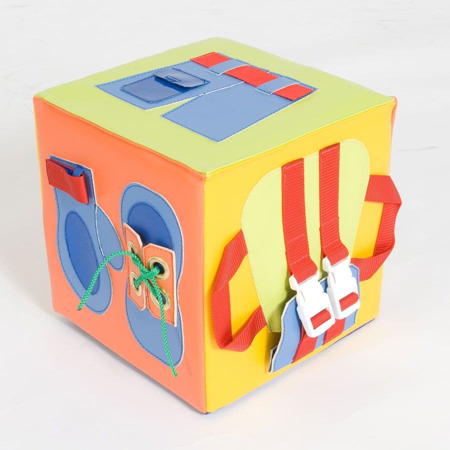 The Getting Ready Cube, The Getting Ready Cube has many benefits including aiding dexterity and practical early years learning. The Getting Ready Cube features six different and recognisable fastenings including press studs, buttons, belt, fastex buckles, zip, Velcro and laces on shoes. The Getting Ready Cube is manufactured from soft touch durable wipe clean vinyl and conforms to UK safety and quality standards. The Getting Ready Cube supports fine motor skills. Each side features a different and recognisa