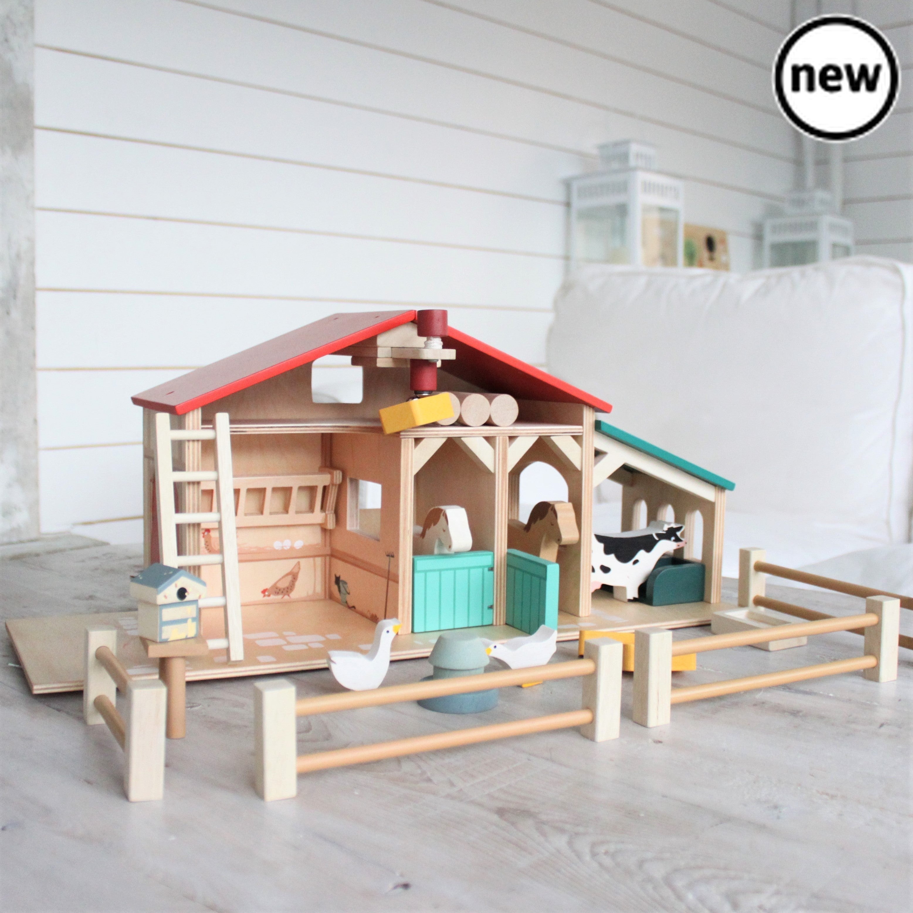 The Tenderleaf Farm, Designed and made by Tender Leaf ToysWelcome to the farm! Made throughout from top quality wood, this farm has been designed to be open and accessible for little hands. Product features: a barn with barn doors and a feeding trough, two stables with opening doors, a ladder leading to hay loft, a pulley system with a magnetic end to lift the hay bales, a cowshed with feeding compartments, four fences, a stile, three hay bales, two geese, two horses, a grain trough, an animal feeding troug