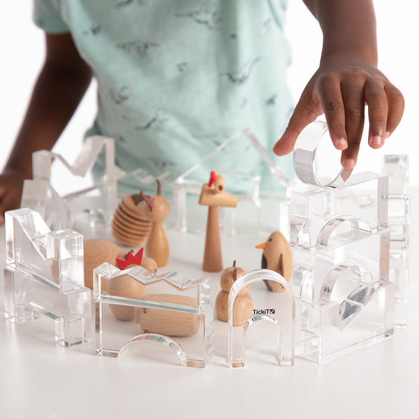 TickiT Clear Crystal Block Set, The TickiT® Clear Crystal Block Set is a magnificent collection of transparent blocks that will ignite your child's creativity and imagination. Designed with safety in mind, the blocks have polished edges, ensuring a smooth and tactile experience for little hands.This 25-piece set includes 17 different shapes, providing endless opportunities for your child to create patterns, sequences, and stunning structures. Let them embark on an imaginative journey and build an ice castle
