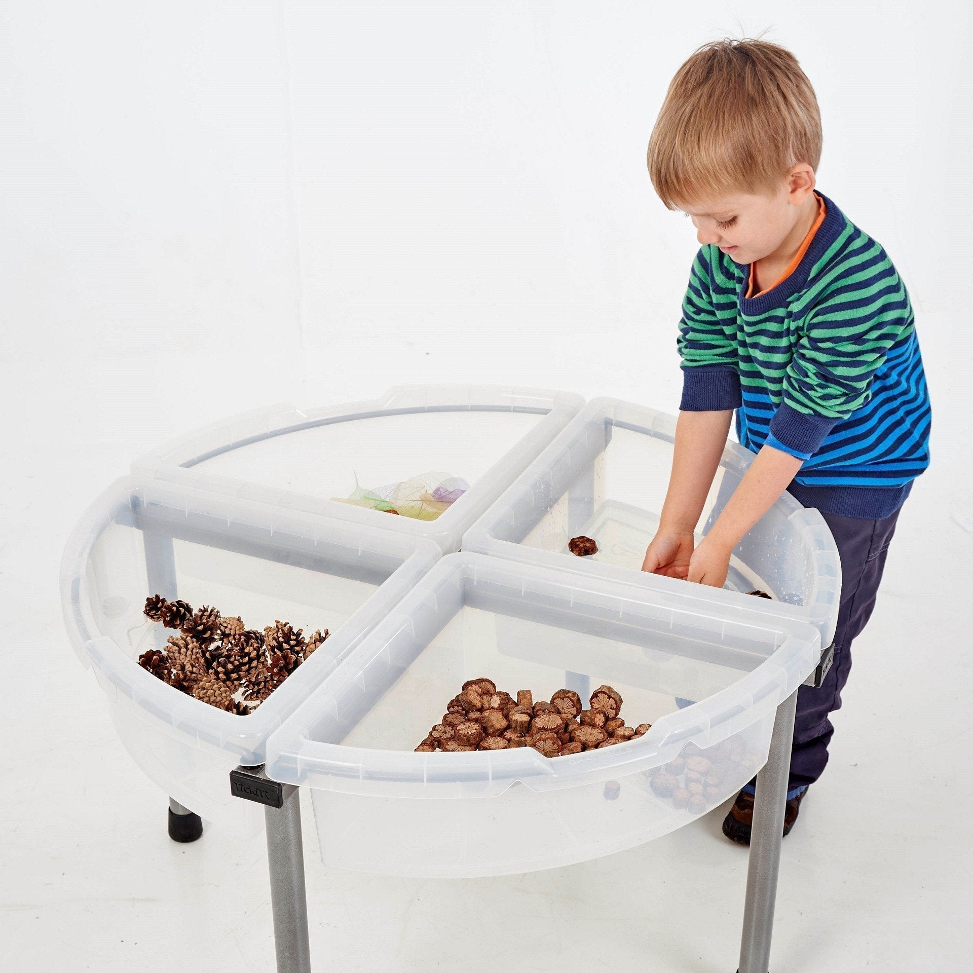 TickiT Exploration Circles Set Clear, Our TickiT Exploration Circles Set offer a great way for your child to play, examine and explore a range of different tactile materials, objects and natural treasures. The 4 quadrant trays come in a clear design.The TickiT Exploration Circles can be filled with a variety of enticing materials such as sand, water, confetti, wood chippings, pebbles, pine cones or even jelly, glitter and spaghetti! Whatever you choose to fill the containers with, the polypropylene trays ar