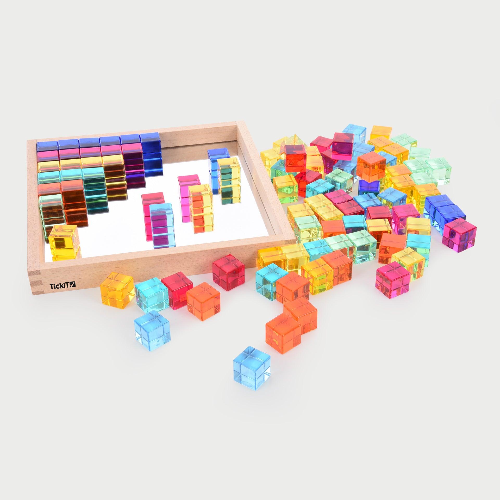 TickiT Gem Cube Mirror Tray, Our TickiT® Gem Cube Mirror Tray is a captivating set of 100 colourful gem cubes in a nicely presented wooden tray. Beautifully finished with tactile smooth edges, the sparkling gem cubes come in 10 bright colours and are ideal for colour sorting, colour mixing, counting and using on a light panel or for colour reflection. Younger children can use them for tower building or pattern making. Older children will find them useful for independent mathematical activities, sequencing a