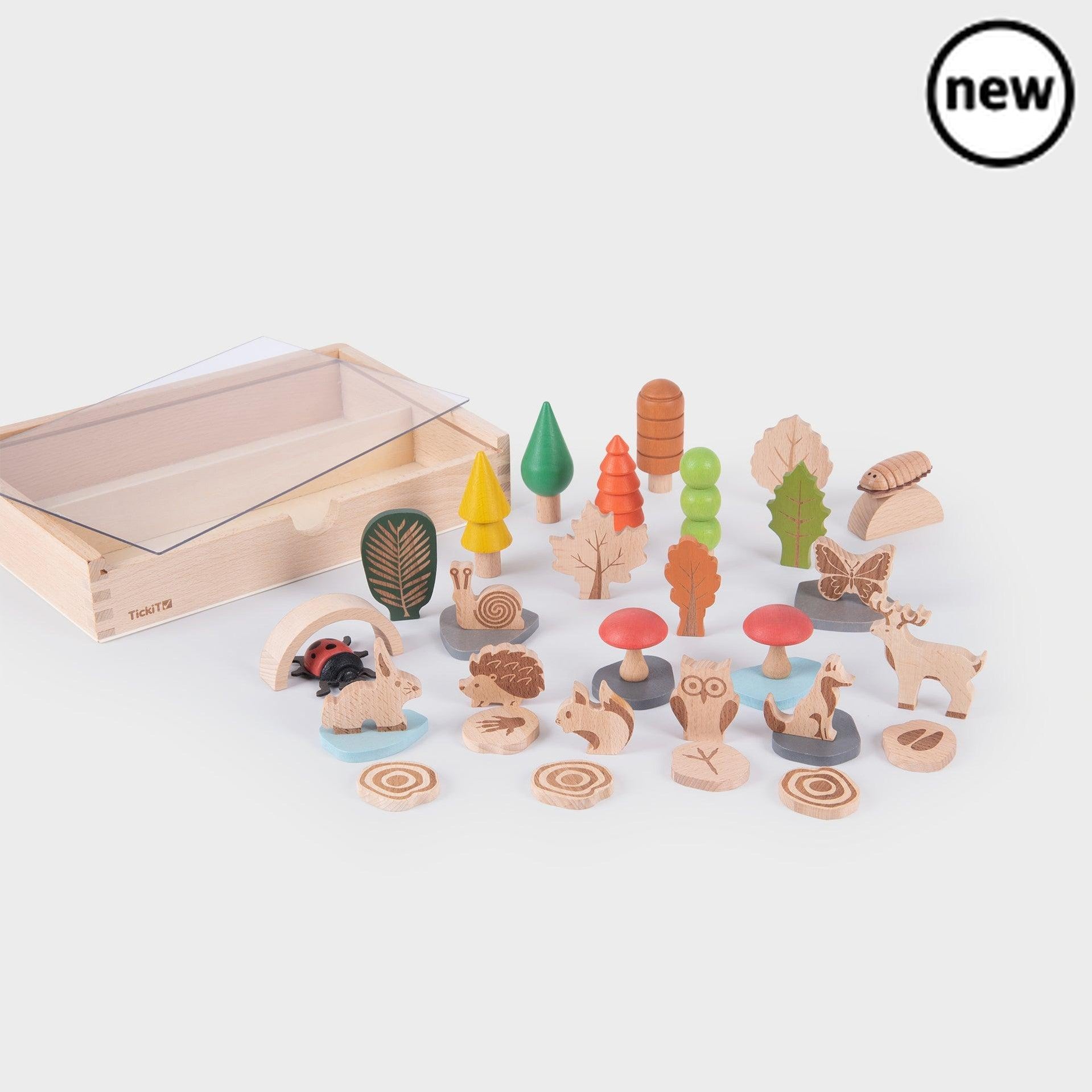 TickiT Woodland Trail Set, With the TickiT Woodland Trail Set, you can bring a piece of the great outdoors right into your home. This beautifully crafted set includes everything your little explorer needs to create their own woodland adventure.Inside the box, you'll find wooden trees, leaves, forest animals, minibeasts, stones, puddles, and even toadstools. Each piece is intricately designed with laser features, creating a tactile indentation design that is not only visually appealing but also perfect for m