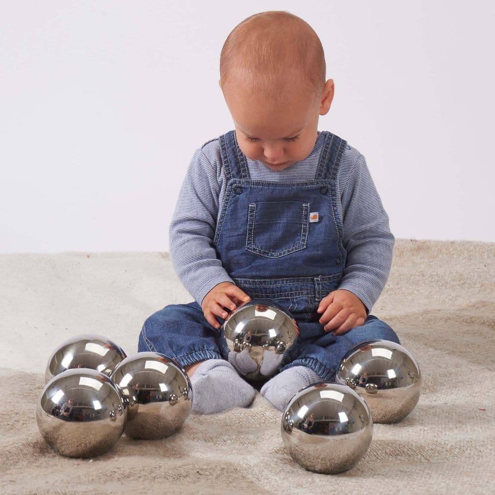 TickiT® Sensory Reflective Mystery Balls, The TickiT® Sensory Reflective Mystery Balls are reflective mirror balls that look identical but all have individual characteristics. Some of the Sensory Reflective Mystery Balls wobble when rolled, or turn and won’t roll in a straight line, some feel funny when twisted, spun or shaken, and others make different shaker or rattle sounds. The shiny mirror surface on the TickiT® Sensory Reflective Mystery Balls provides a distorted fish-eye lens reflection which is fas