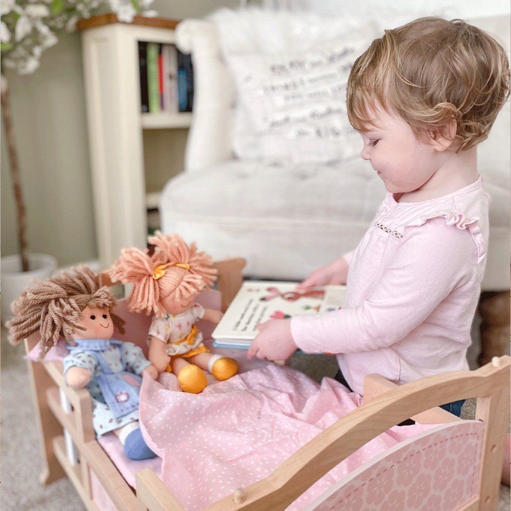 Tidlo 2-in-1 Dolls Cot, Send your doll to sleep in style with the Tidlo 2-in-1 Doll Cradle. This wooden dolls cot features contoured edges and rounded corners for extra safety. Children will love tucking their doll into their cot and rocking them to sleep. The baby doll cot has a two in one design that changes from a rocking cradle to a single bed - if you have two then they can be stacked to make bunk beds!The Tidlo baby doll cot comes complete with a delightful 3-piece bedding set. Suitable for most stand