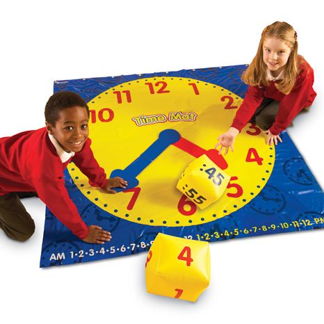 Time activity mat, Use the Time activity mat to reinforce time-telling skills by playing engaging games! Invites students to roll the cubes, then place the plastic hands or position themselves on the mat to show the time they have rolled. This Time activity mat reinforces time-telling in 5 minute increments. There is also a time number line along the bottom of the mat for elapsed time activities. Featuring colour-coded plastic clock hands, young learners will quickly see the difference between hours and min