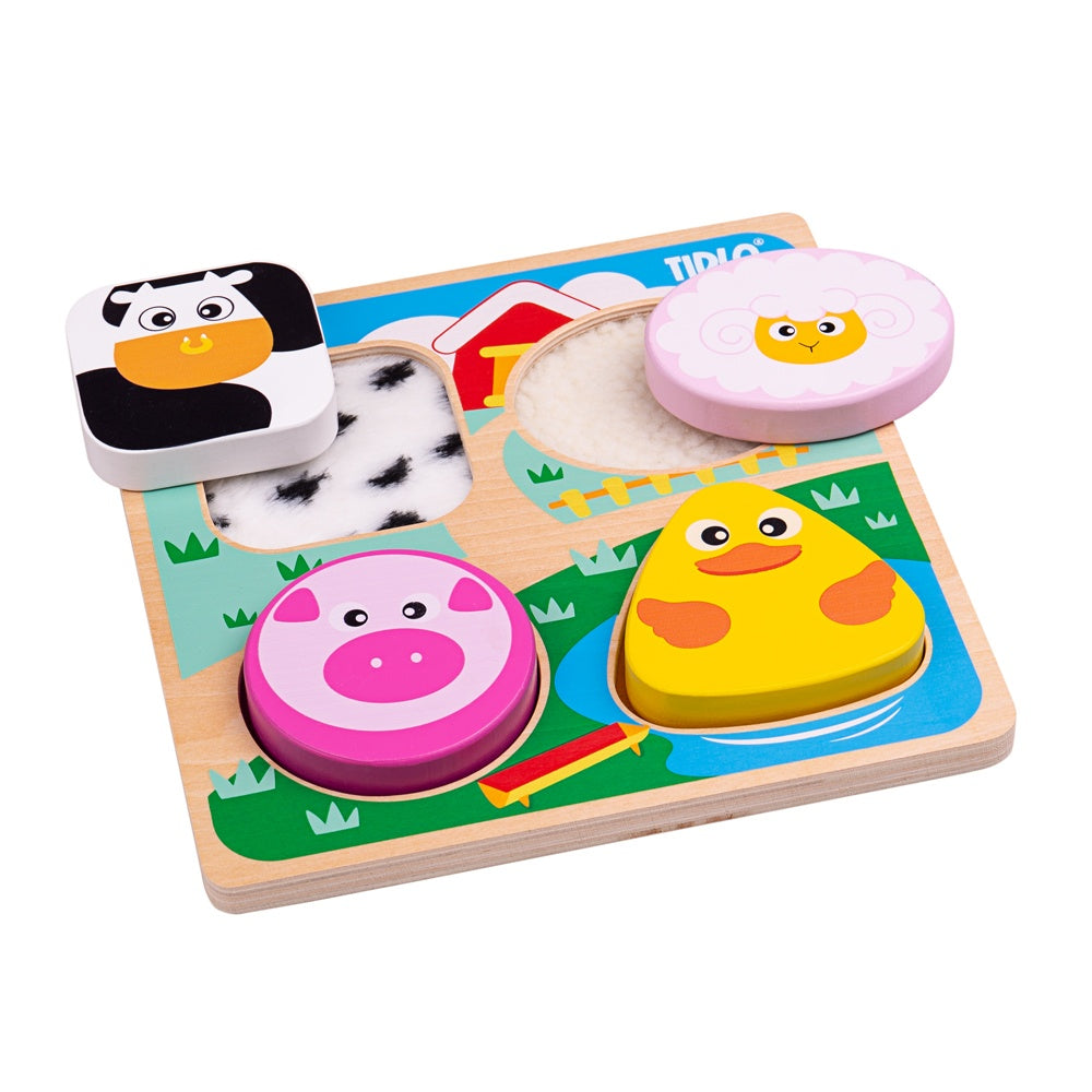 Touch and Feel Puzzle Farm, Feel the woolly lamb and the feathery duck with this stunning Touch and Feel Puzzle Farm. These are just two of the exciting textures to explore on this delightful Touch and Feel Farm Puzzle. The animals that are illustrated in this colourful farm scene are a pig, duck, sheep and cow. The Tidlo Touch and Feel Puzzles are a diverse range of sensory puzzle boards great for early development. Remove the four wooden puzzle pieces to reveal different, appropriately textured materials 