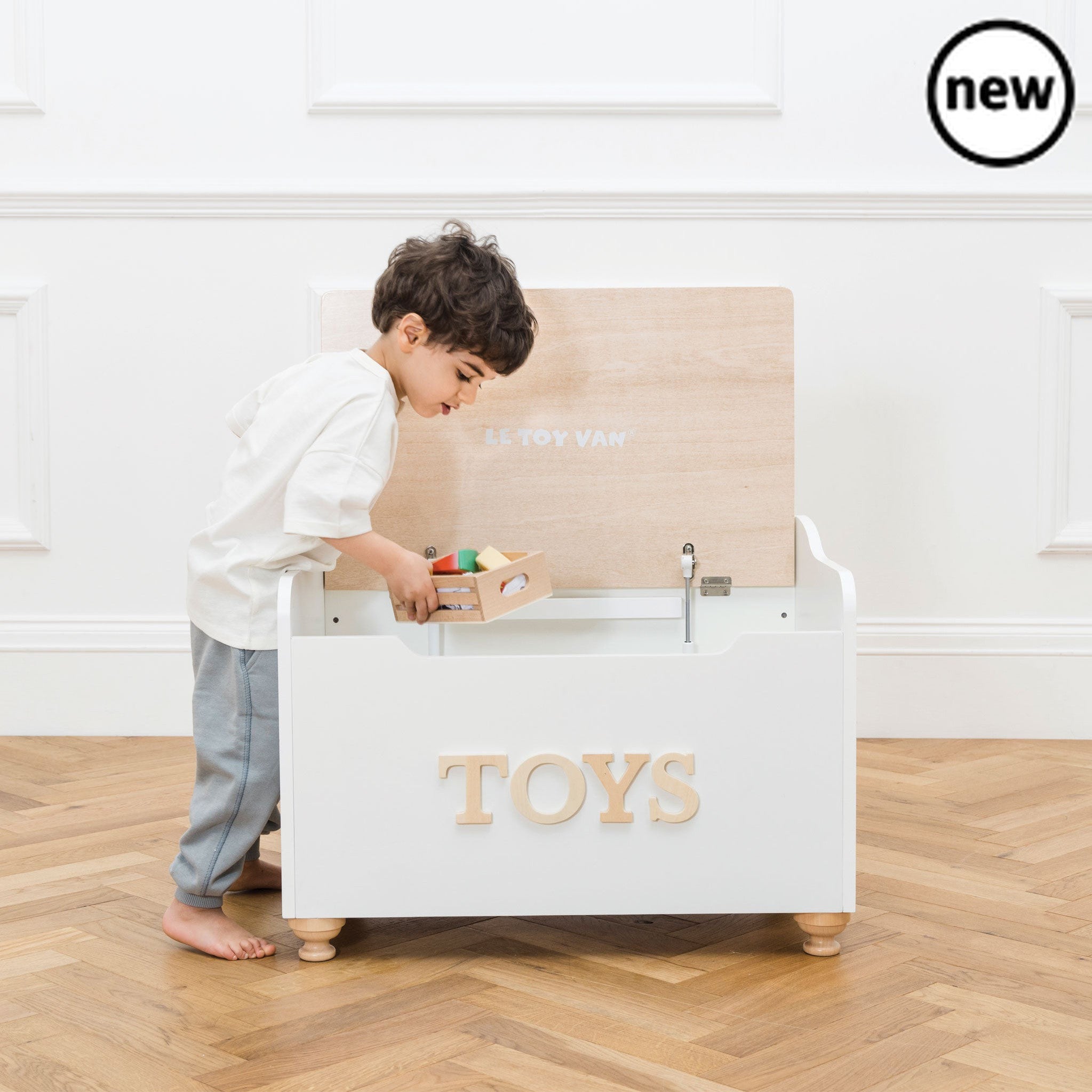 Toy Storage Box, Description This exquisitely hand-crafted wooden toy box is the perfect place for children to store their treasures and toy accessories. Keep the playroom or kids room tidy and stylish with this elegant storage box with lid which also doubles as a handy seat! With many appealing features including child safe soft closing hinges, turned wooden feet and embossed lettering, all finished in neutral classic white and natural wood finish. A wonderful furniture piece that will withstand the test o