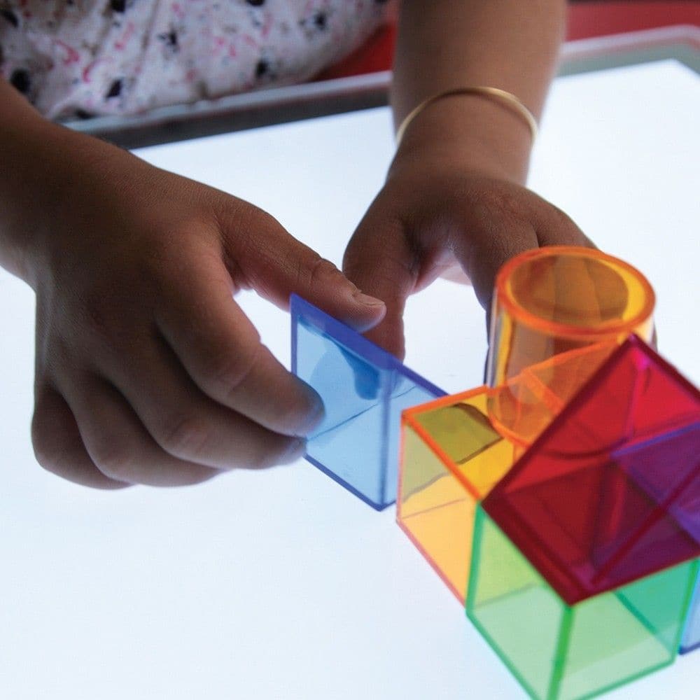 Translucent Colour Blocks, TickiT® Translucent Colour Blocks is a set of colour acrylic 3D building blocks in six shapes, perfect for use on a light panel where towers and structures look even more impressive with the light shining through the colourful buildings! The Translucent Colour Blocks are ideal for developing fine motor skills through construction and encouraging imaginative play. The Translucent Colour Blocks set includes circular and rectangular pillars, triangular prisms, cubes and bridges. The 