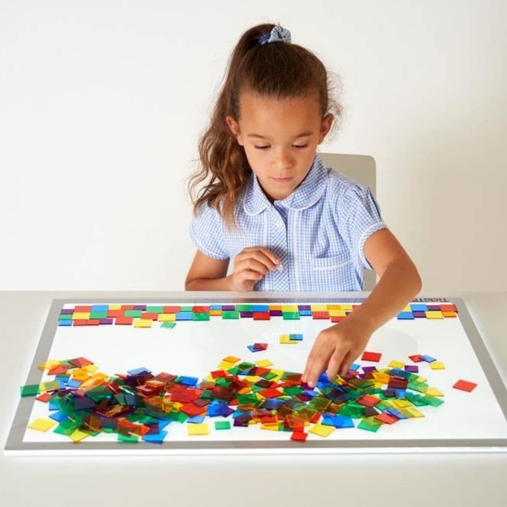 Translucent Colour Squares - Pk300, Introducing the Translucent Colour Squares, the perfect addition to your child's learning activities! These clear square tiles come in six vibrant colors, making them ideal for counting, sorting, pattern-making, and color recognition activities. The Translucent Colour Squares set includes 100 tiles in 25mm size and 200 tiles in 19mm size, giving your child the freedom to create and explore their imagination. These Translucent Colour Squares are perfect for use on a light 