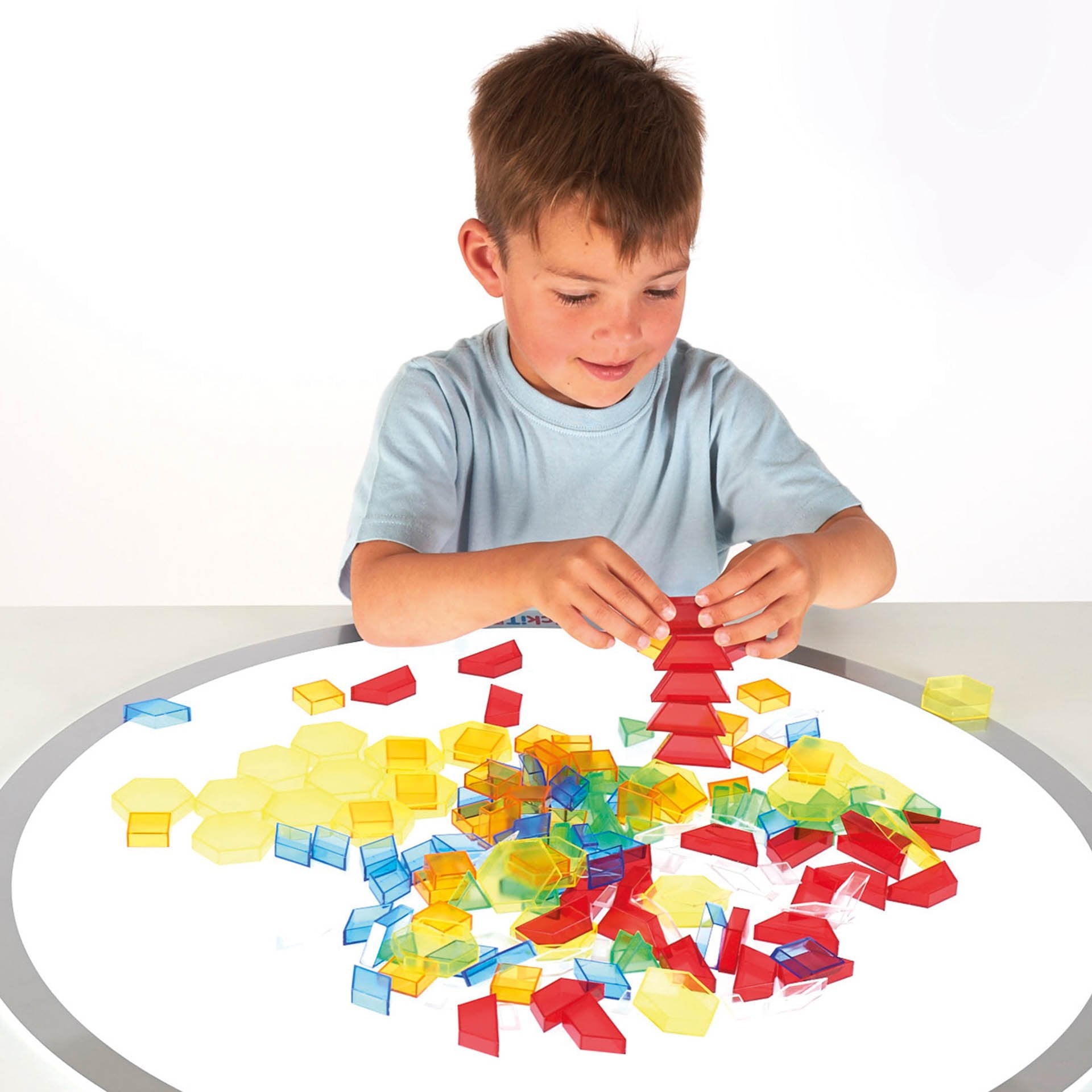 Translucent Hollow Pattern Blocks, TickiT® Translucent Hollow Pattern Blocks is a set of colour acrylic pattern blocks in six different shapes. Perfect for use on a light panel where shapes and patterns look even more impressive with the light shining through the colourful blocks! Ideal for developing fine motor skills through construction, pattern and sequencing activities, counting and sorting, learning about shapes and colour and colour mixing. Set includes: 180 blocks in 6 colours and 6 shapes (yellow h