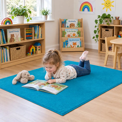 Tufty Rugs – child reading on the blue 150 x 100 cm rug