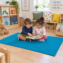 Tufty Rugs – children sharing a book on the blue 150 x 100 cm rug