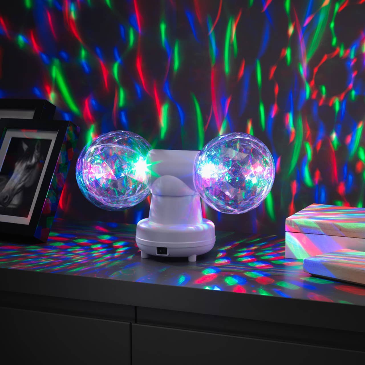 Twin Disco Ball in White, Give your Children the greatest light show on earth with these twin rotating disco balls!A stunning light effect which will look great in any dark room or bedroom creating a fantastic sensory focus in the room full of colour and light. This compact gadget is a party that you can move around. It has two rotating mirror balls, measuring 10 cm each.These reflect multi-coloured LED lights, creating a flurry of colour on your walls! This light is fantastic for house parties (did we ment