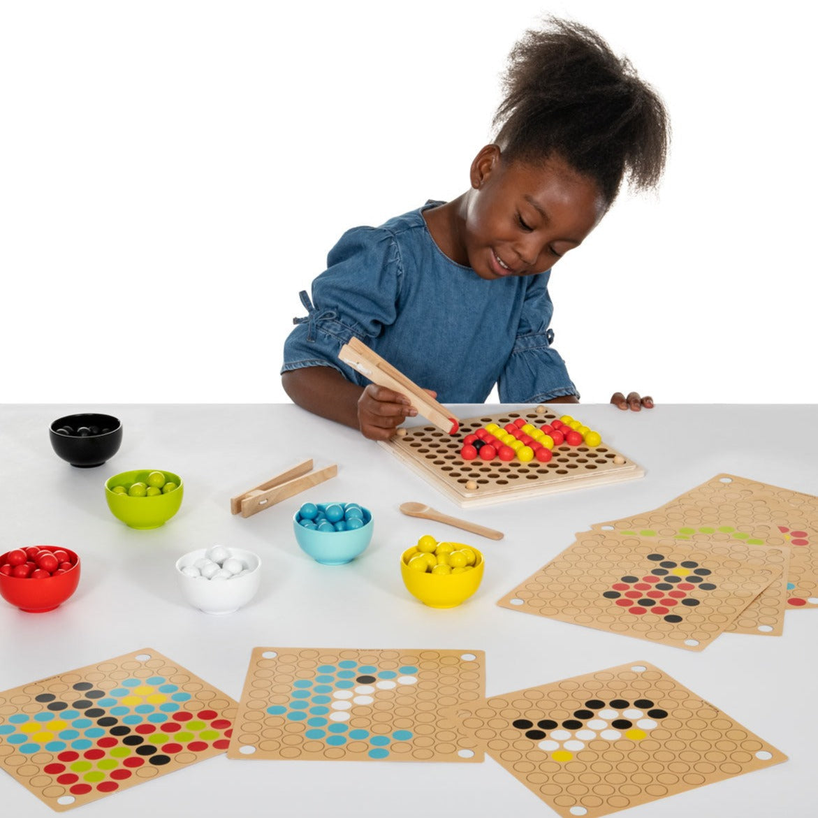 Wooden Fine Motor Pattern Balls, Introducing our fine motor skills development set, perfect for younger children who are just starting to learn about colours, patterns and cognitive development. This set includes everything your child needs to explore their creativity and improve their fine motor skills. Featuring 10 double-sided workcards with a range of patterns and designs, children can create pictures that include animals, shapes and many more. The set also includes a baseboard and overlay, 111 balls in