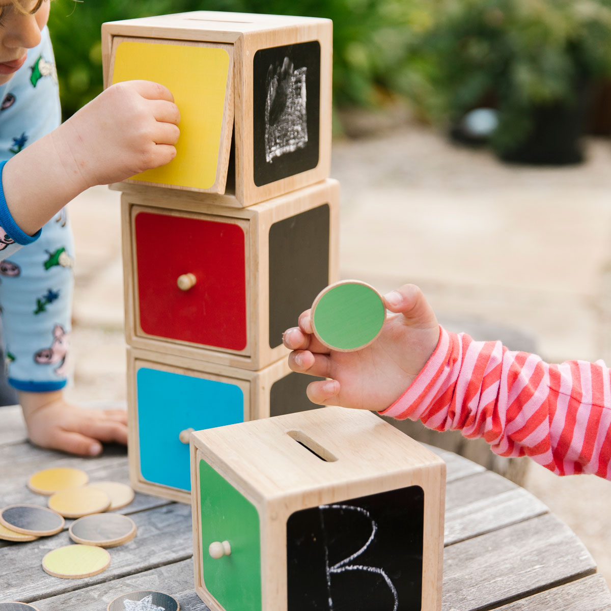 Wooden Post Sort ’n’ Play, Introducing our 44 piece interactive scene set, perfect for open-ended play and early learning skills development. The set includes 4 generously sized boxes, each with a different coloured door and 40 discs in an array of shades to match. The discs feature a chalkboard side and a coloured side, offering endless opportunities for learning and creativity.With their bright colours and unique design, these boxes are ideal for children who love to explore, count, and match. They're per