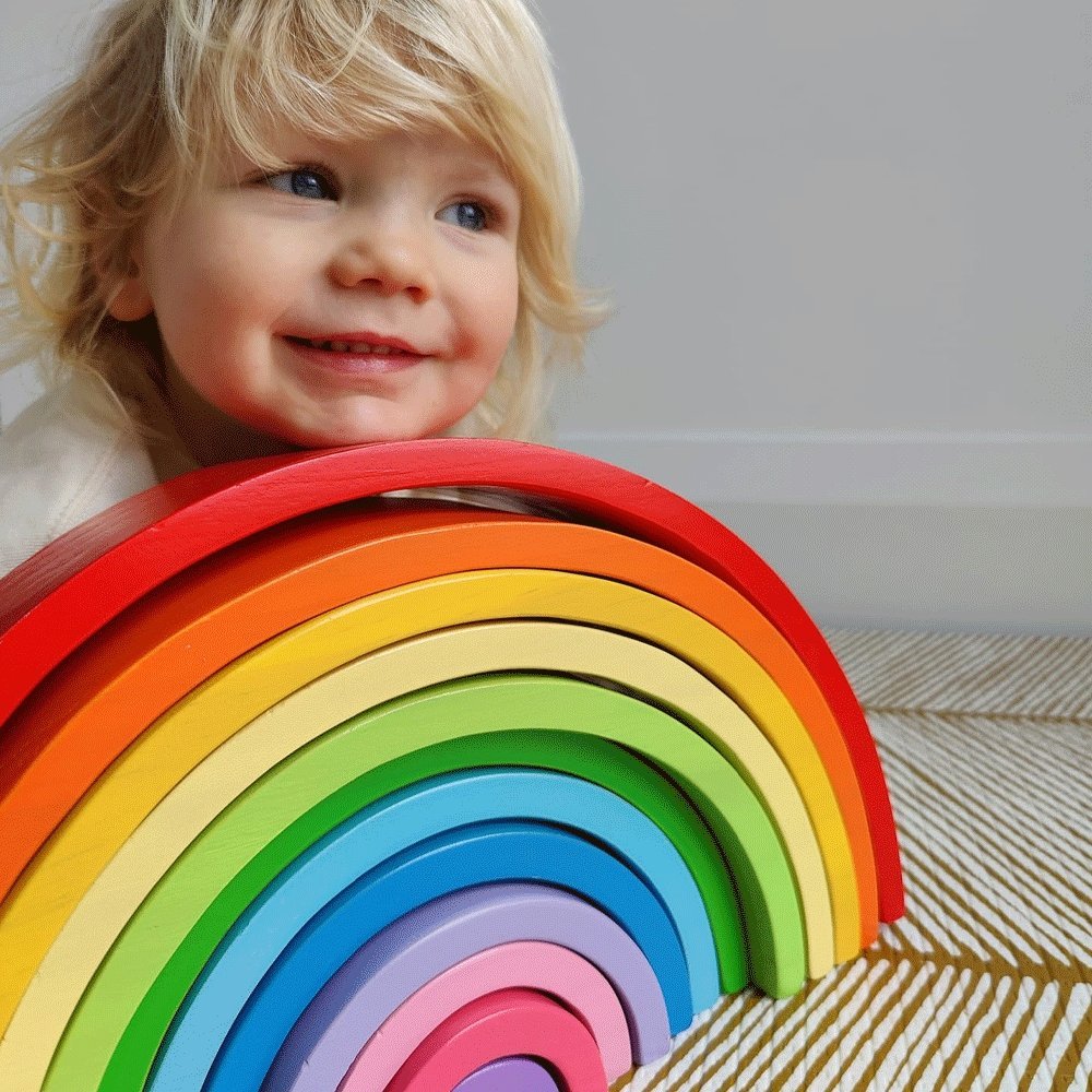 Wooden Rainbow Stacking Toy-Large, The play possibilities are endless with this versatile and sturdy Large Rainbow Stacking Toy. With no guidelines or rules, it is a brilliant Montessori toy. With these stacking toy arches, little hands can assemble a variety of shapes and objects while learning all about different sizes and colours. Made from solid wood and coloured with non-toxic paints. Once playtime is over, this Rainbow Stacker makes a fun decoration for your little ones bedroom or nursery. Develops cr