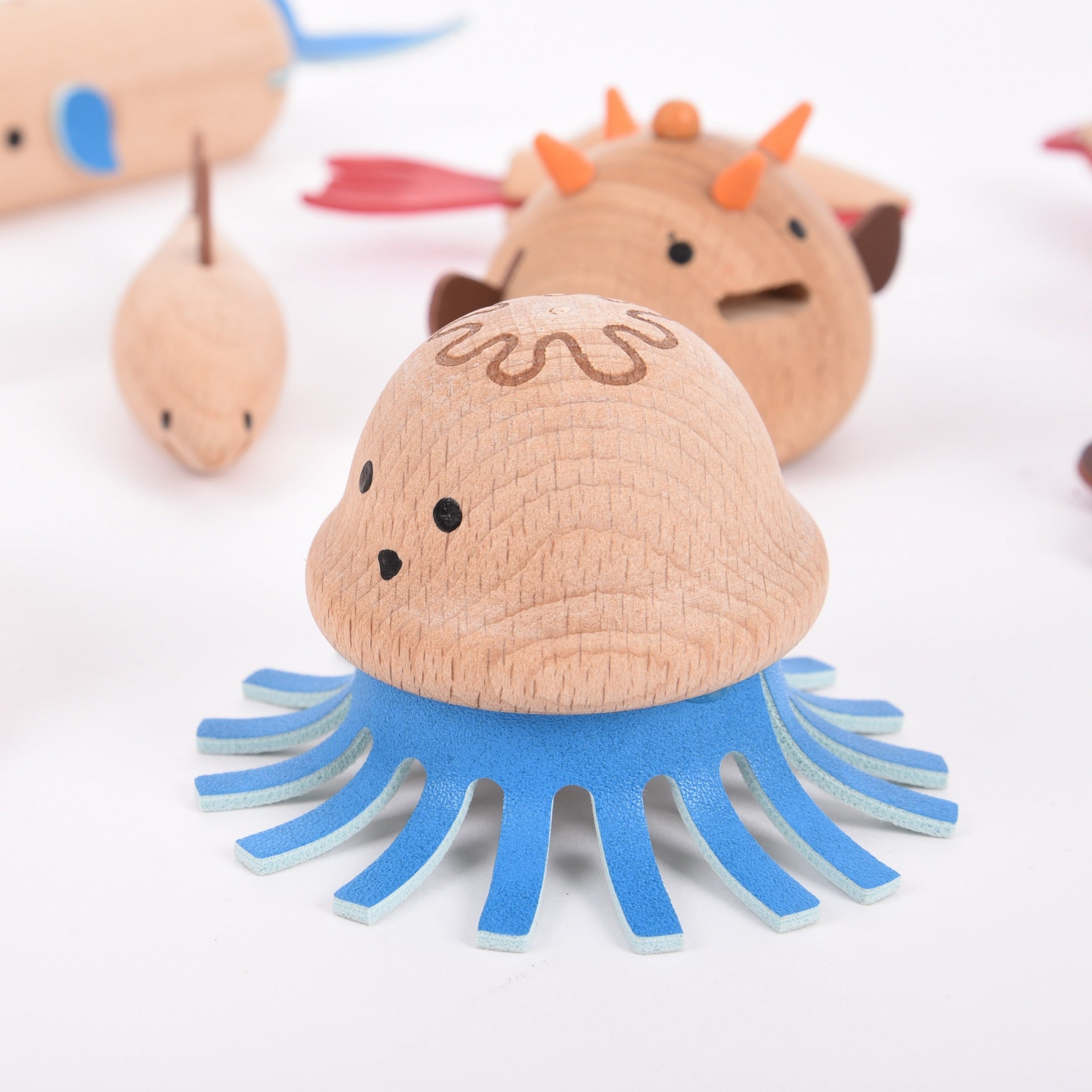 Wooden Sea Creatures, Your child will love creating their own underwater adventure with our TickiT® Wooden Sea Creatures. A beautiful set of 10 marine animals made from beautiful solid beechwood, including a puffer fish, sea horse, squid, shark, lobster, jellyfish, crab, octopus, turtle and whale. Natural and smooth with simple printed features and faux leather embellishments, these charming creatures are fun and tactile. Your child will have a 'whale' of a time using them in imaginative play, small world p