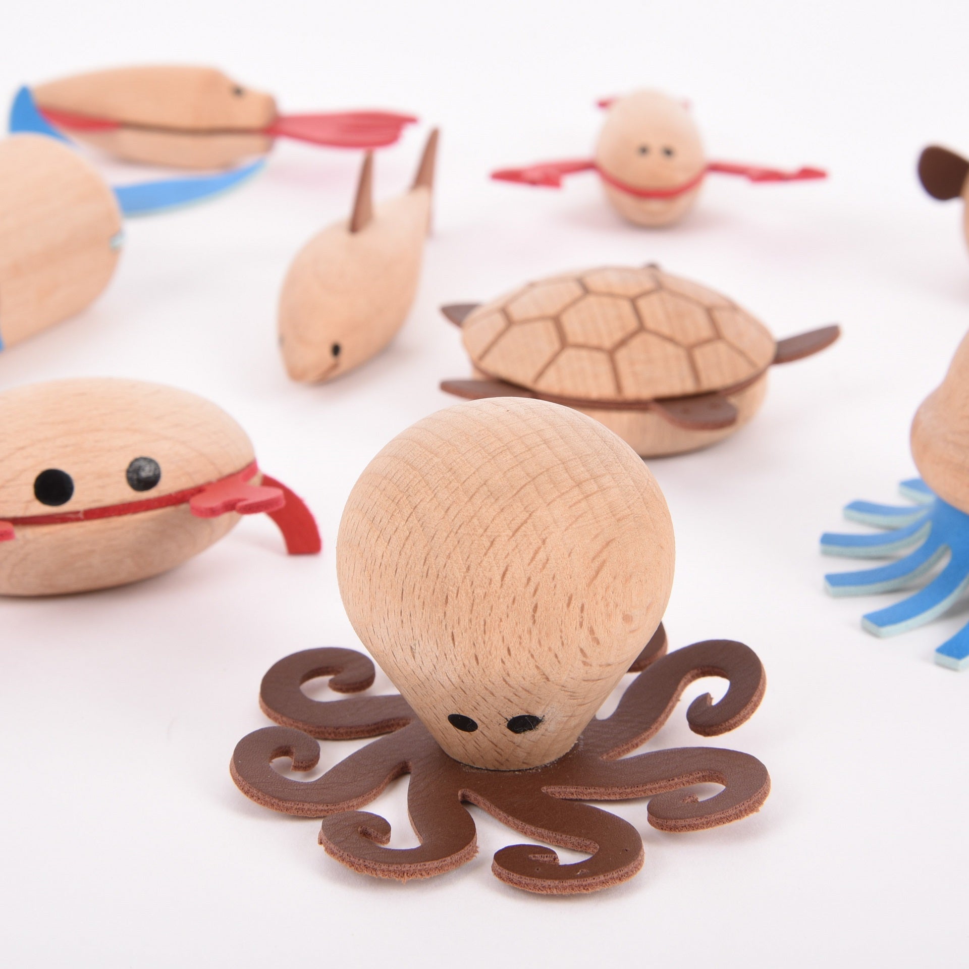 Wooden Sea Creatures, Your child will love creating their own underwater adventure with our TickiT® Wooden Sea Creatures. A beautiful set of 10 marine animals made from beautiful solid beechwood, including a puffer fish, sea horse, squid, shark, lobster, jellyfish, crab, octopus, turtle and whale. Natural and smooth with simple printed features and faux leather embellishments, these charming creatures are fun and tactile. Your child will have a 'whale' of a time using them in imaginative play, small world p