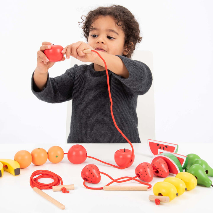 Wooden Threading Fruits 24 Pack, The Wooden Threading Fruits are perfect for promoting hand-eye and sequencing skills. Large, wooden pieces of fruit easy enough for small hands to manipulate. The Wooden Threading Fruits set is excellent for developing fine motor skills as well as sorting, matching and sequencing.Who doesn't like fruit! These Wooden Lacing Fruits are great for enabling children to improve on their fine motor skills whilst trying to weave the thread through the holes, they can even try to ide